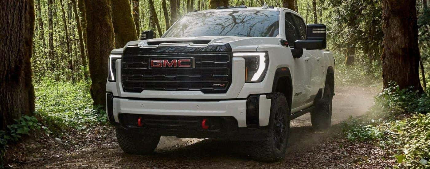 White 2026 GMC Sierra 2500 HD AT4 driving to a dealer