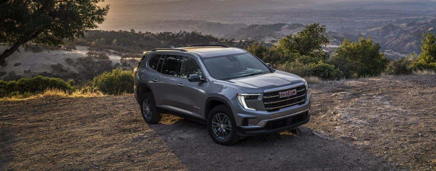 A gray 2025 GMC Acadia Elevation parked off-road