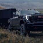 A black 2026 GMC Sierra 2500 HD towing a trailer.