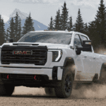White 2026 GMC Sierra 2500 HD drifting off-road