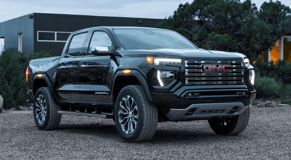 Black 2026 GMC Canyon Denali parked in front of a home