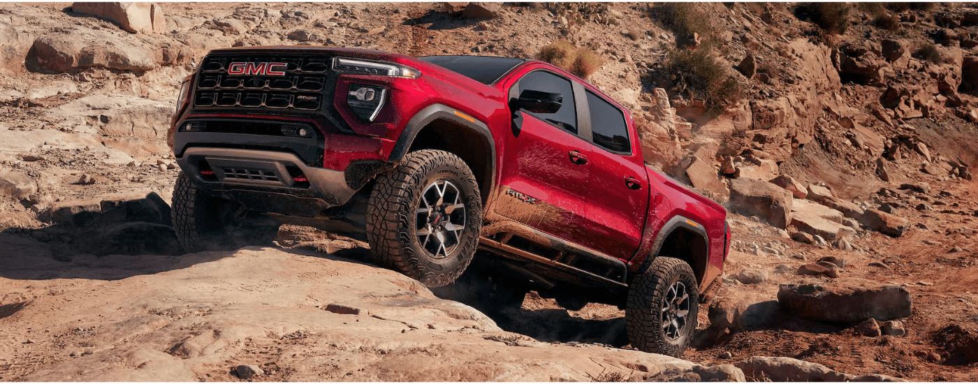 Red 2026 GMC Canyon AT4 parked on a rock