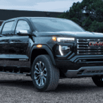 Black 2026 GMC Canyon parked in front of a home