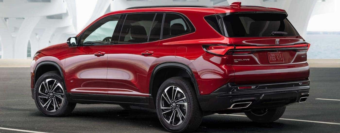 Rear of a red 2025 Buick Enclave parked on a parking lot.