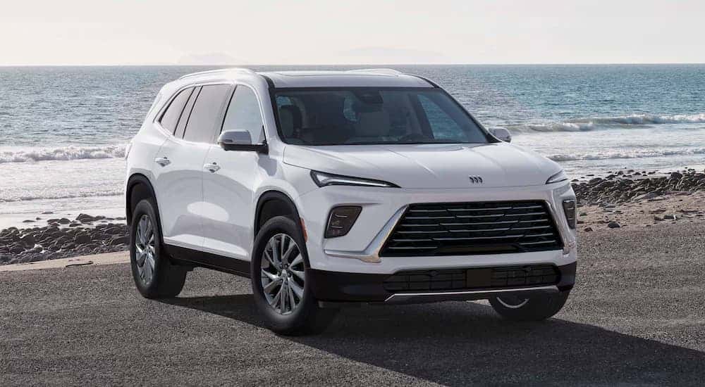 White 2026 Buick Enclave parked near a lake.