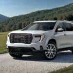 A white 2026 GMC Acadia parked on a driveway.