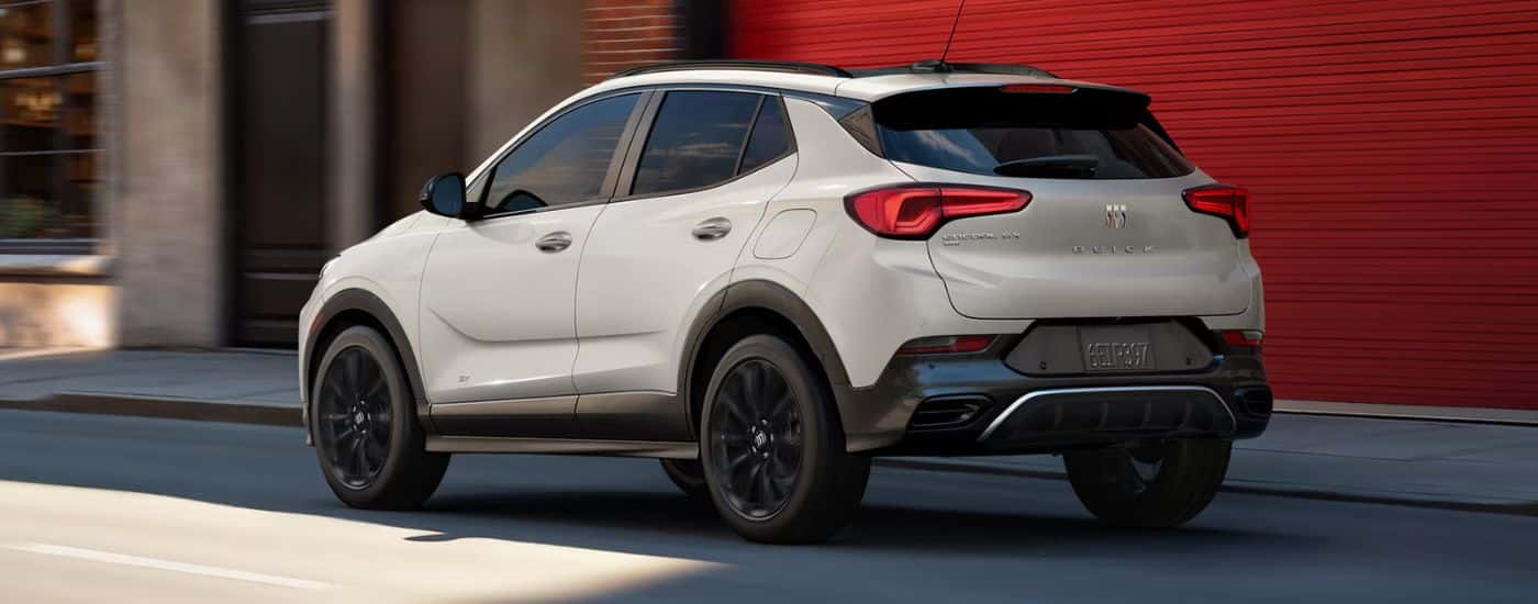 White 2026 Buick Encore GX driving down a city street
