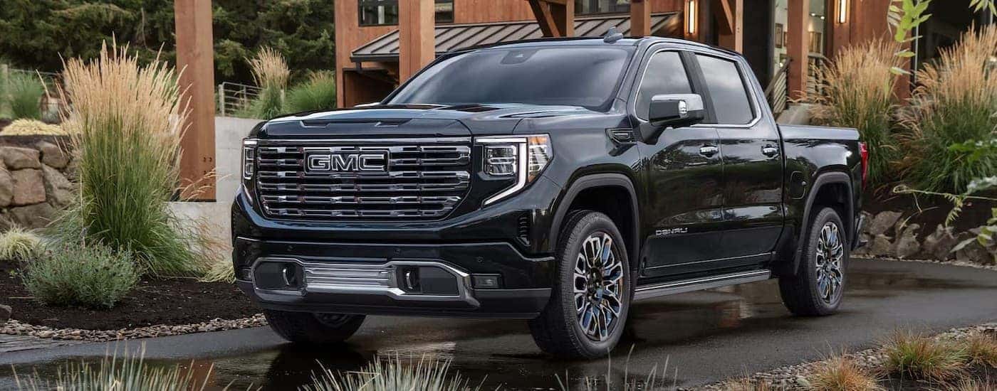 A black 2026 GMC Sierra 1500 parked near a house.