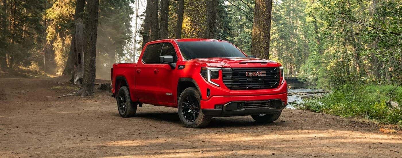 A red 2026 GMC Sierra 1500 parked in the forest.