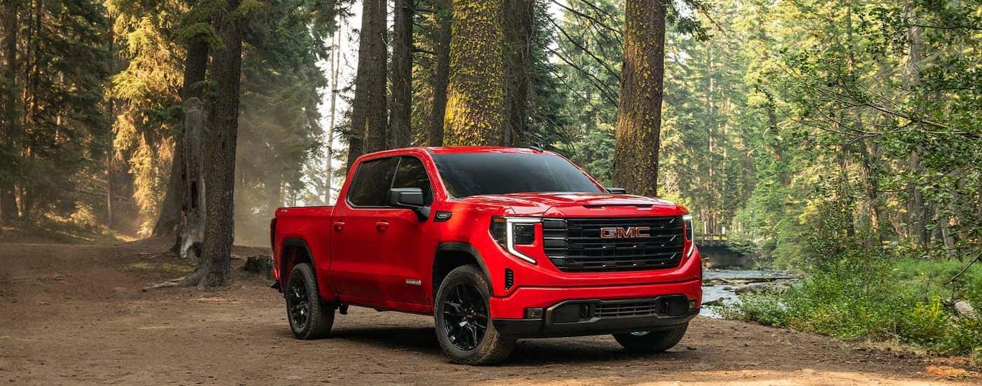 A red 2026 GMC Sierra 1500 parked in the forest.