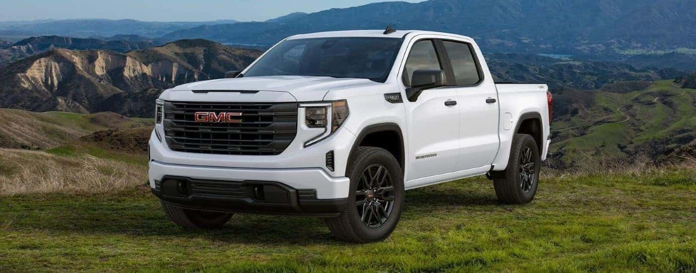 A white 2024 GMC Sierra 1500 Pro Graphite Edition parked at an overlook.