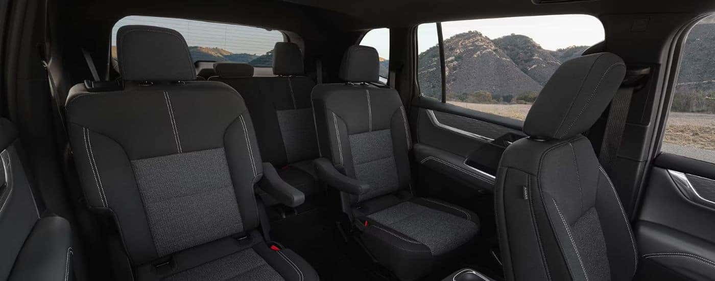 Black three-row interior of a 2026 GMC Acadia.
