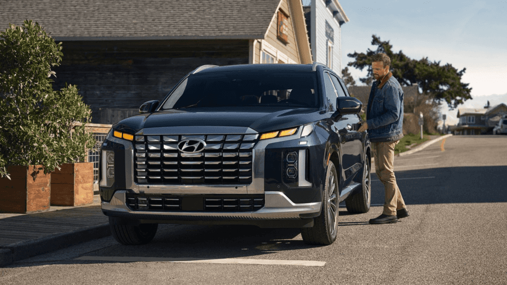 The hood of this SUV is almost as tall as the small car. I wonder