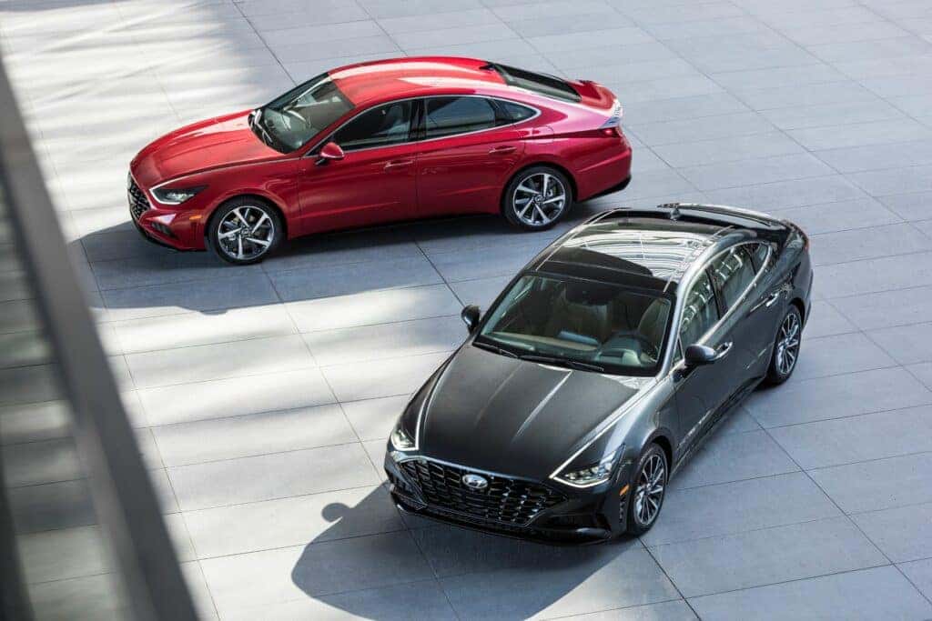 Two different 2023 Hyundai Sonata cars parked next to one another