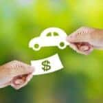 Hand with paper money and car shape. new car buy concept