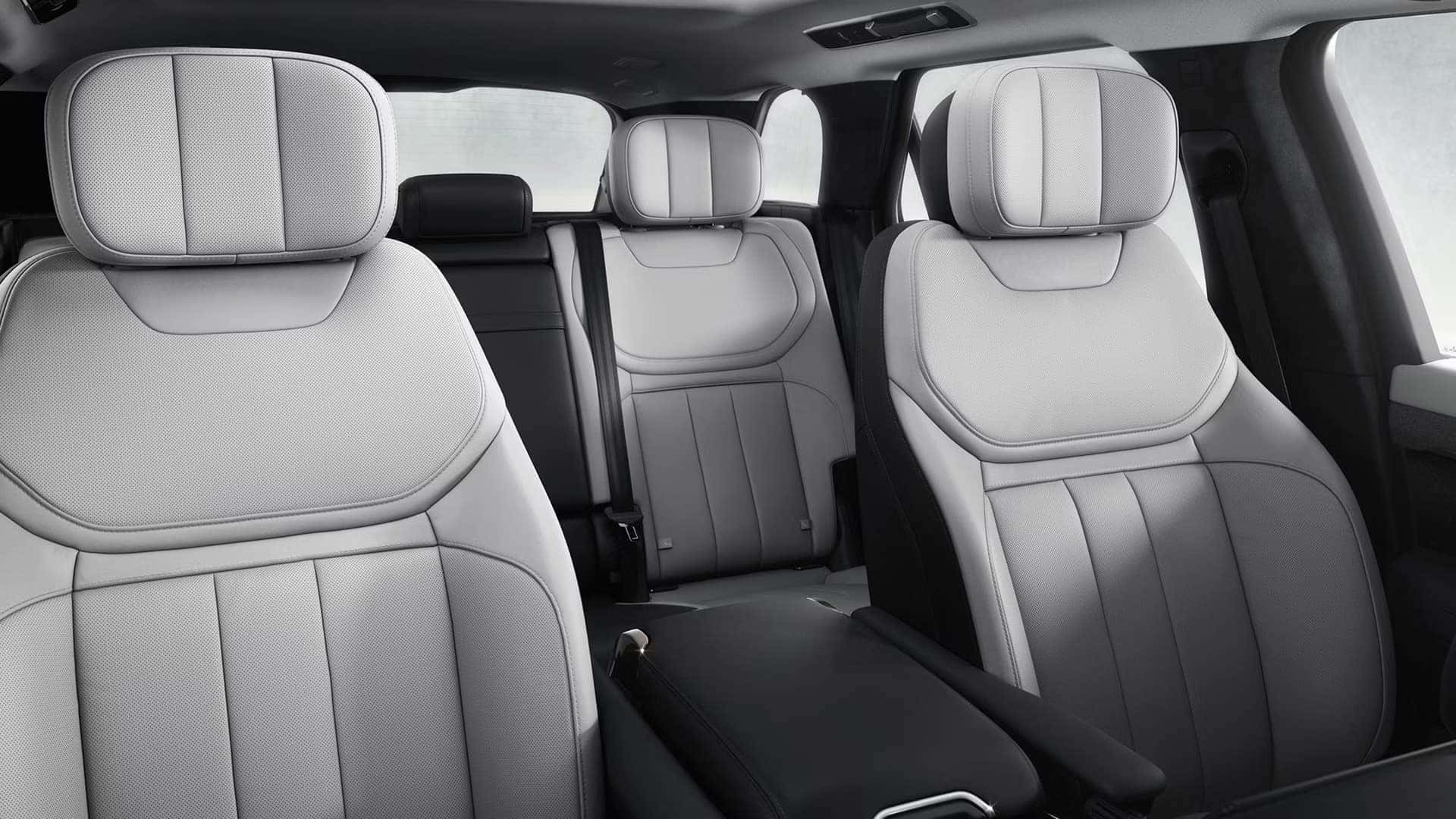 Interior view showing luxury white leather seats in Range Rover Sport with three-row seating configuration
