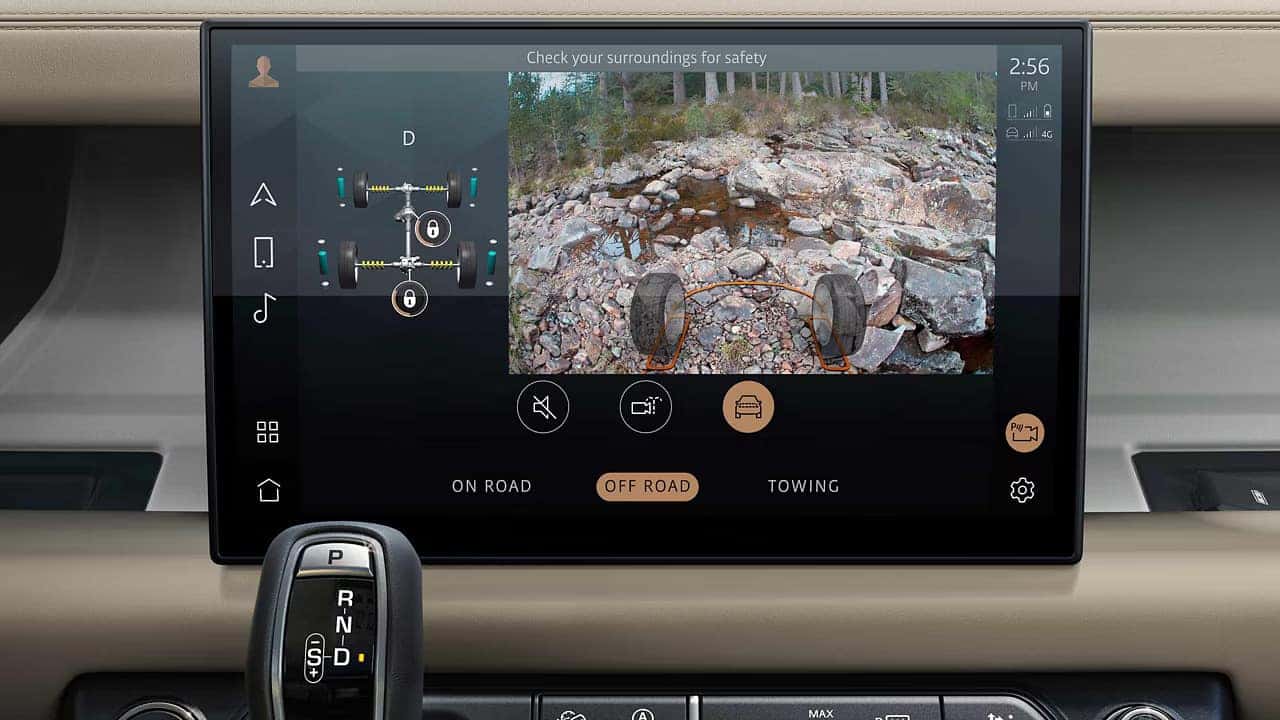 Off-road vehicle display screen showing terrain management system with front camera view of rocky terrain and "OFF ROAD" mode selected