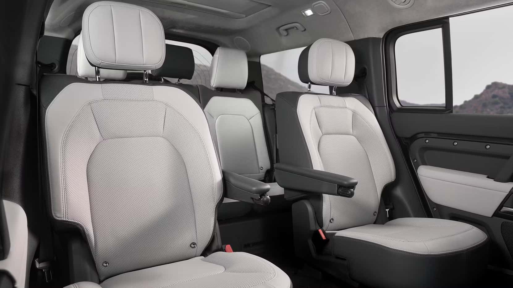 cream leather interior of a 2025 defender 130 with 2nd row captains chairs