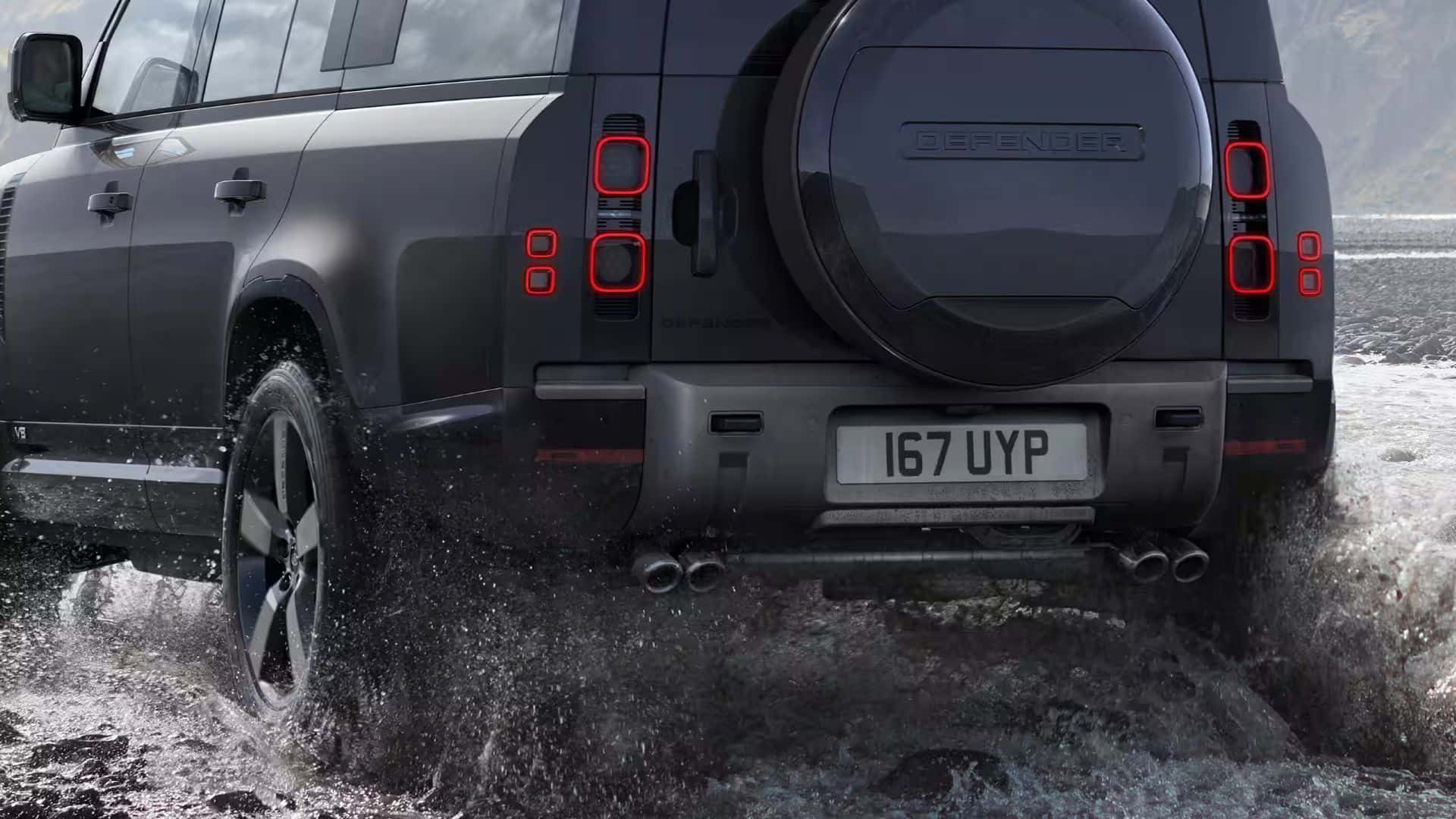 a black defender 130 driving in a water