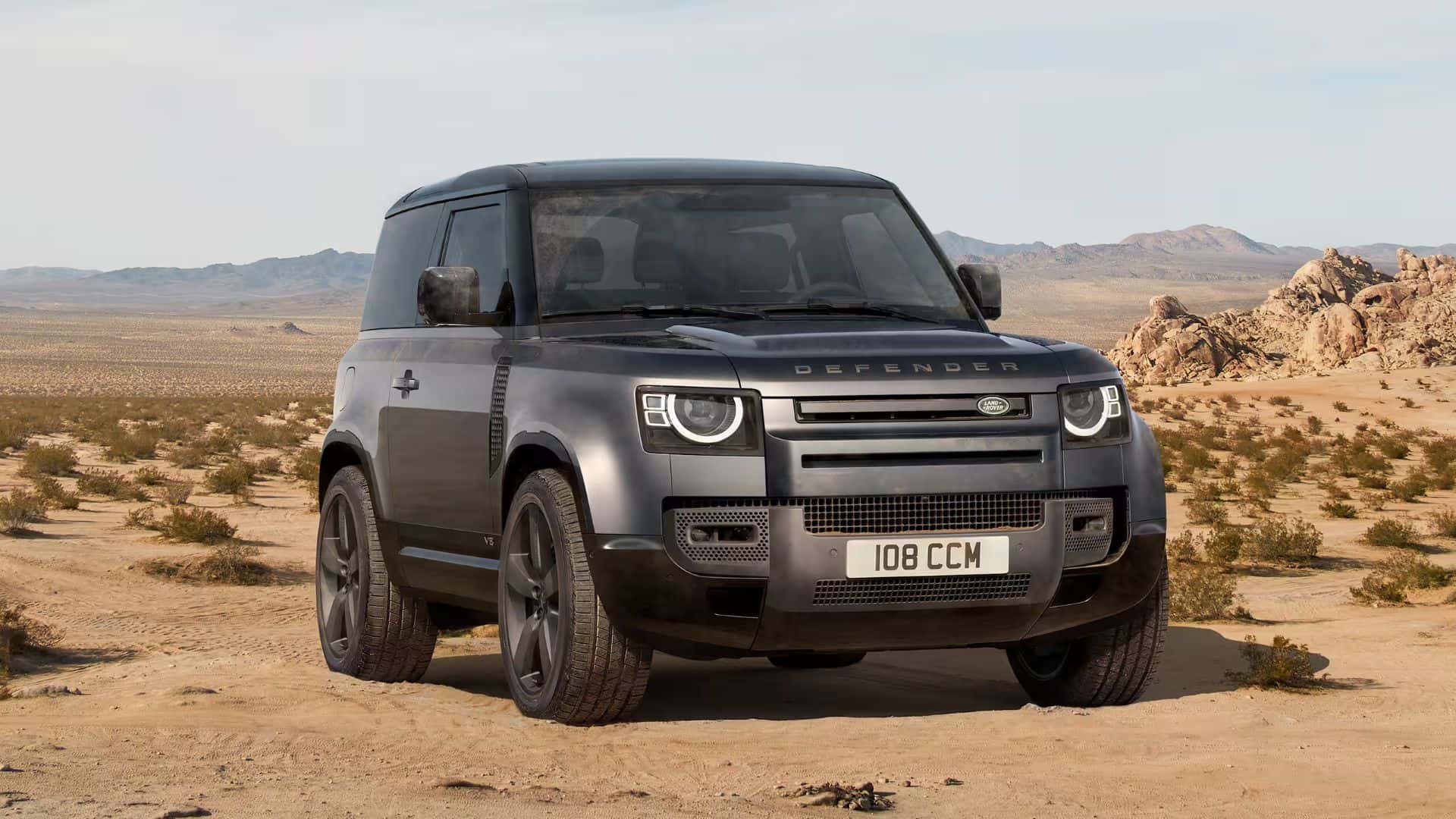 exterior view of a 2025 defender 90 parked on a dessert terrain
