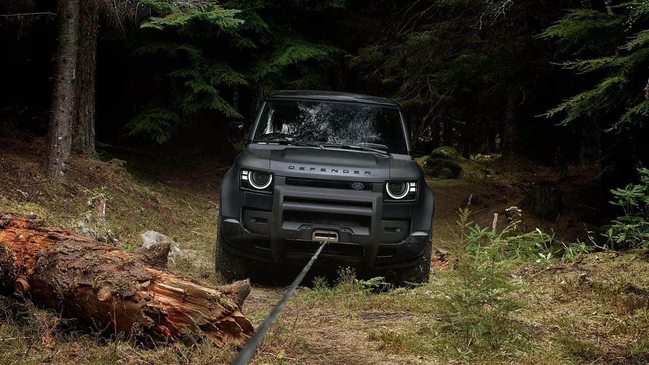 2026 defender 90 with a wench attached to the front end and a tree