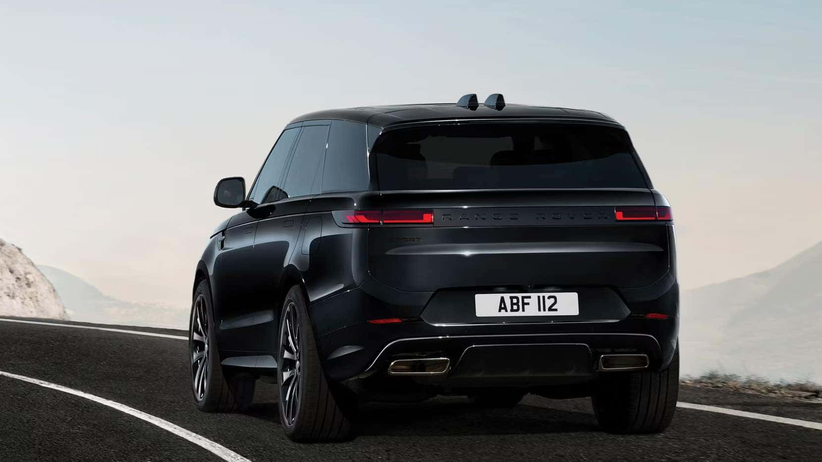 a 2026 range rover driving on a road