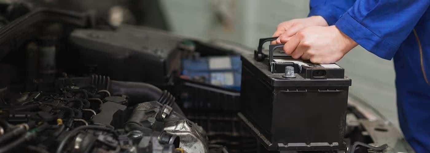 land rover service technician changing a battery