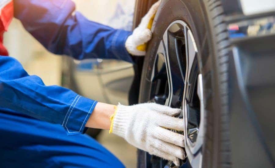 land rover technician putting a new tire on a defender vehicle