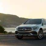 Mercedes Benz SUV parked by lake
