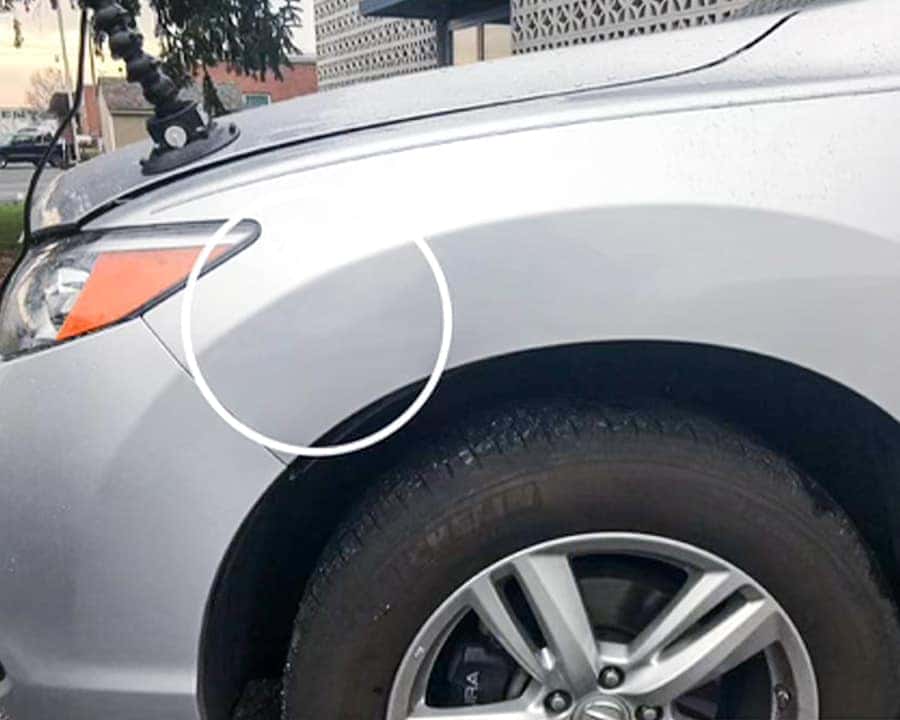 Vehicle with minor dent after paintless dent repair