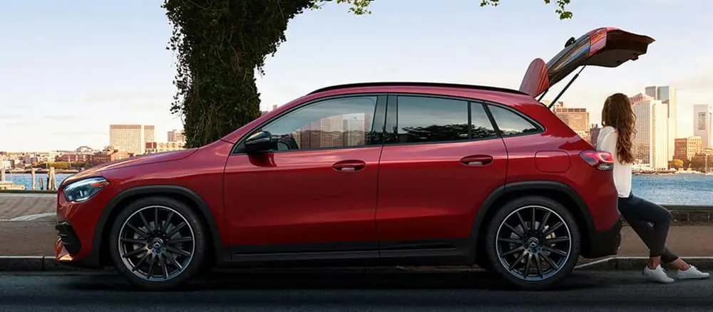 Red Mercedes-Benz GLA With Girl Sitting in Trunk