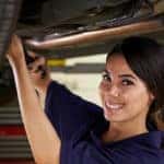 Female Auto Mechanic Working Under Car