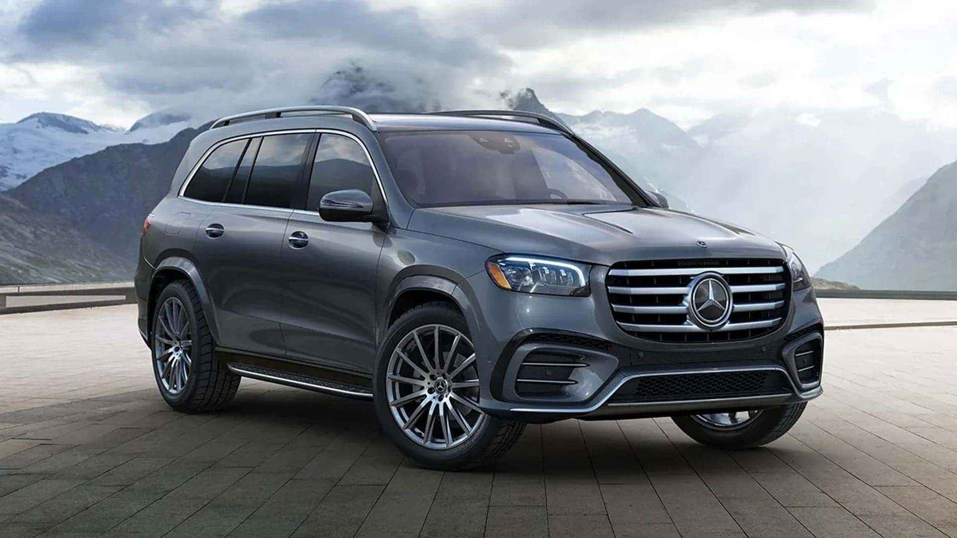2025 GLS SUV parked in front of clouds and mountains