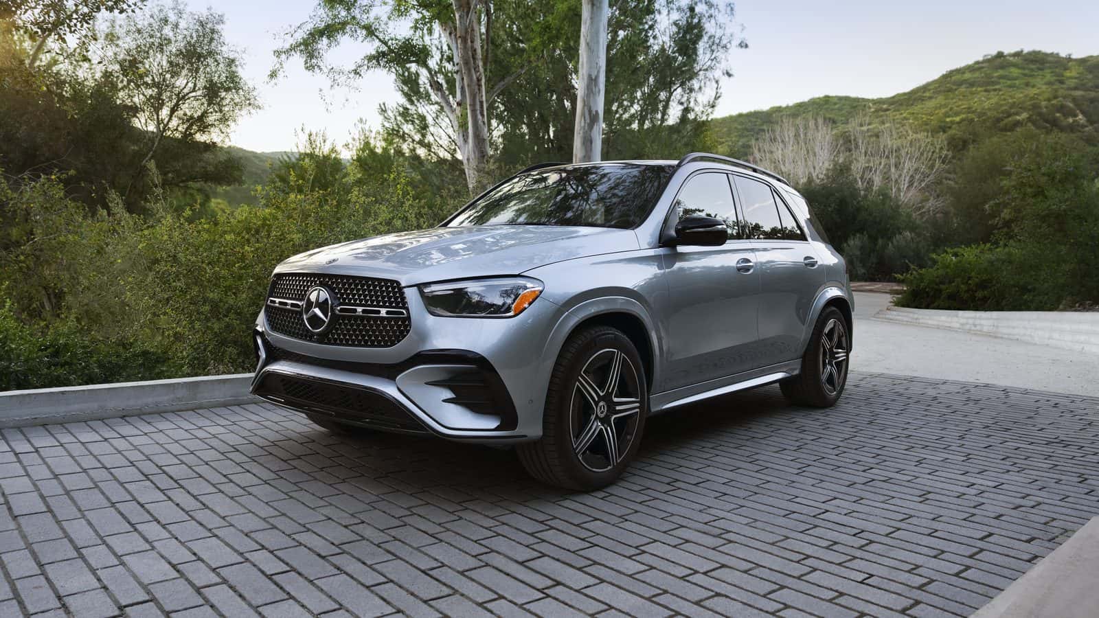 2026 Mercedes-Benz GLE 450 4MATIC SUV in silver, front three-quarter view on a stone driveway