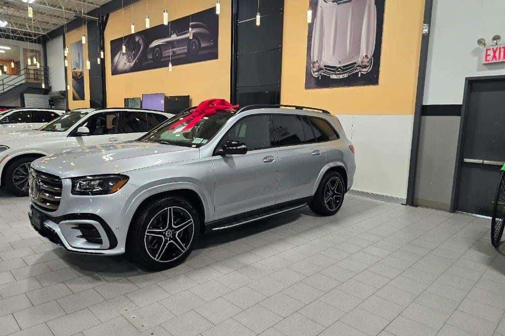 A new Mercedes-Benz GLS with a red bow, ready for delivery