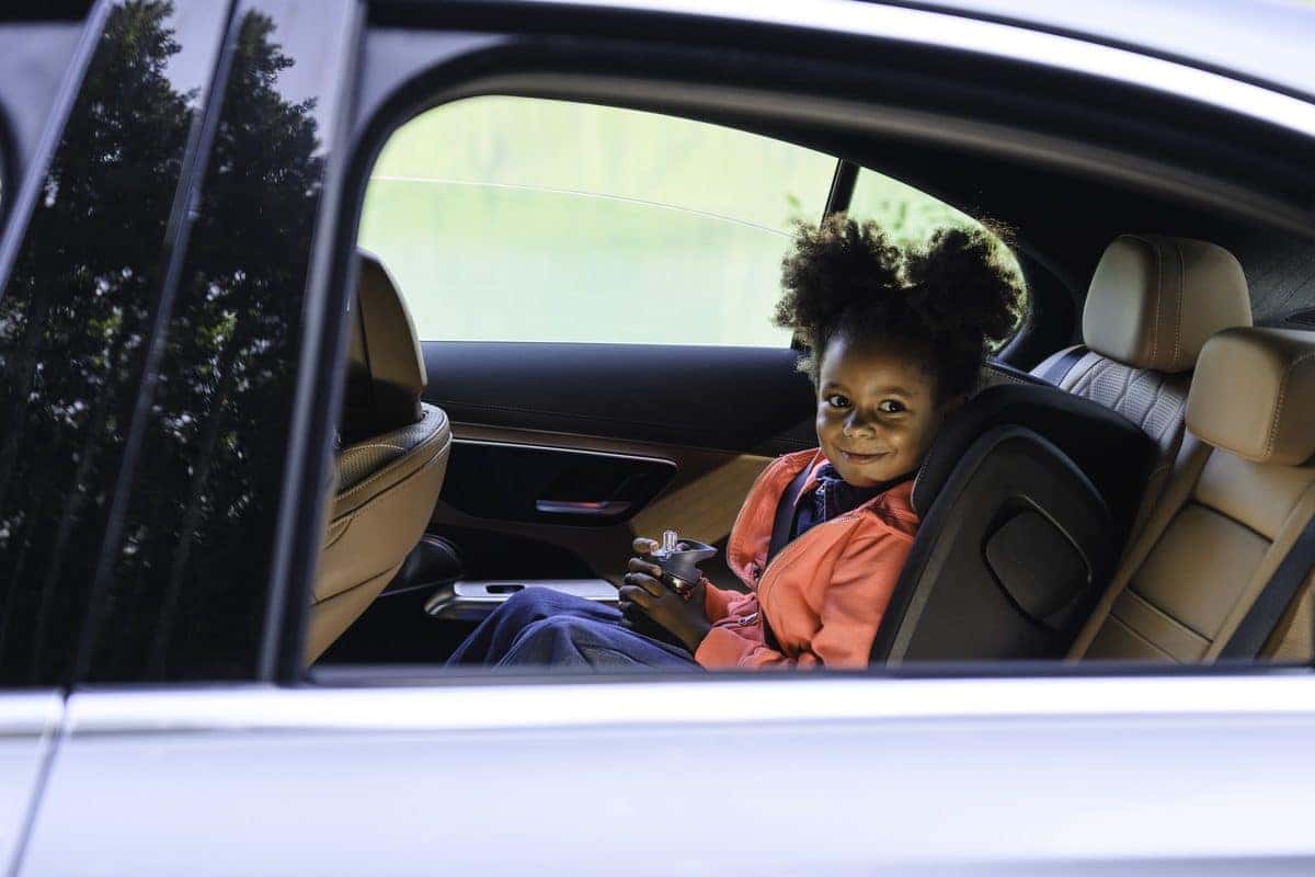 Child relaxing in the back seat of a Mercedes-Benz E-Class