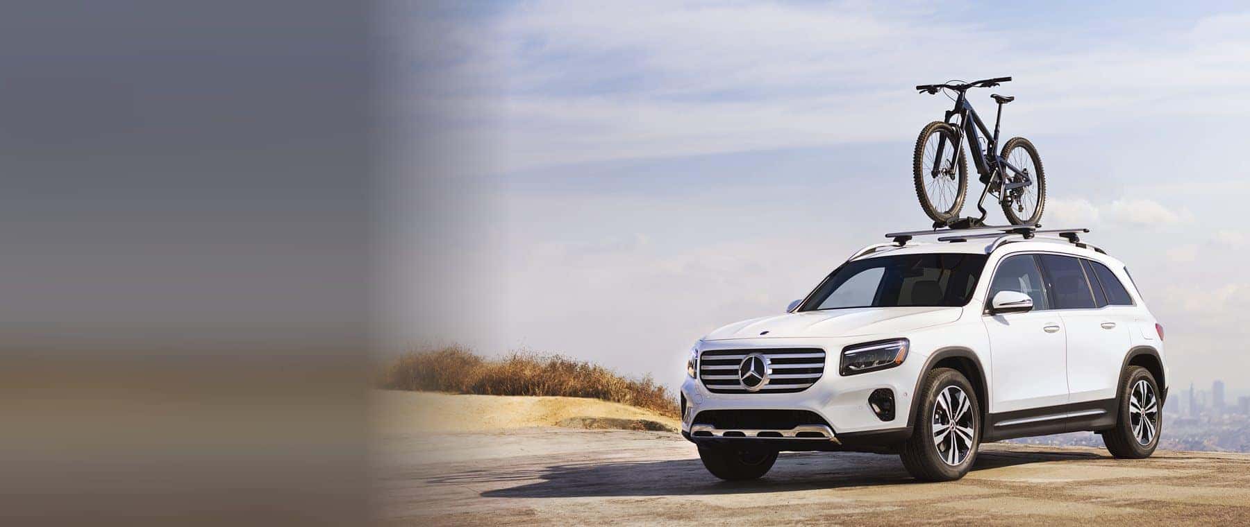 GLB SUV, front three-quarter view, with roof-mounted bike rack accessory (MB portal photo). Optional equipment shown.