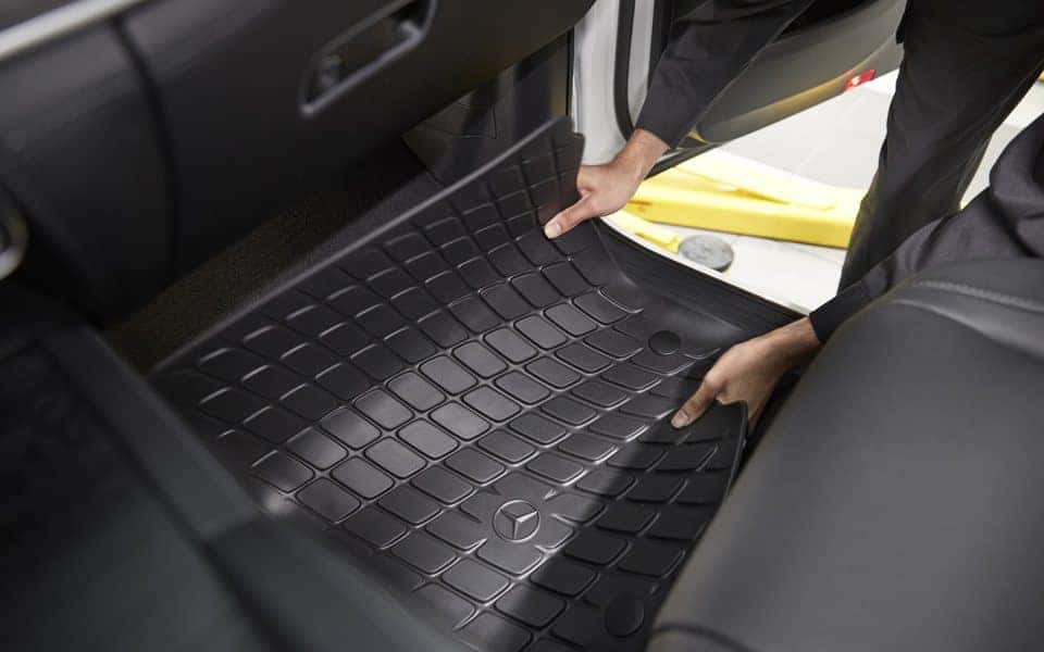 Technician fitting a genuine Mercedes-Benz all-season floor mat