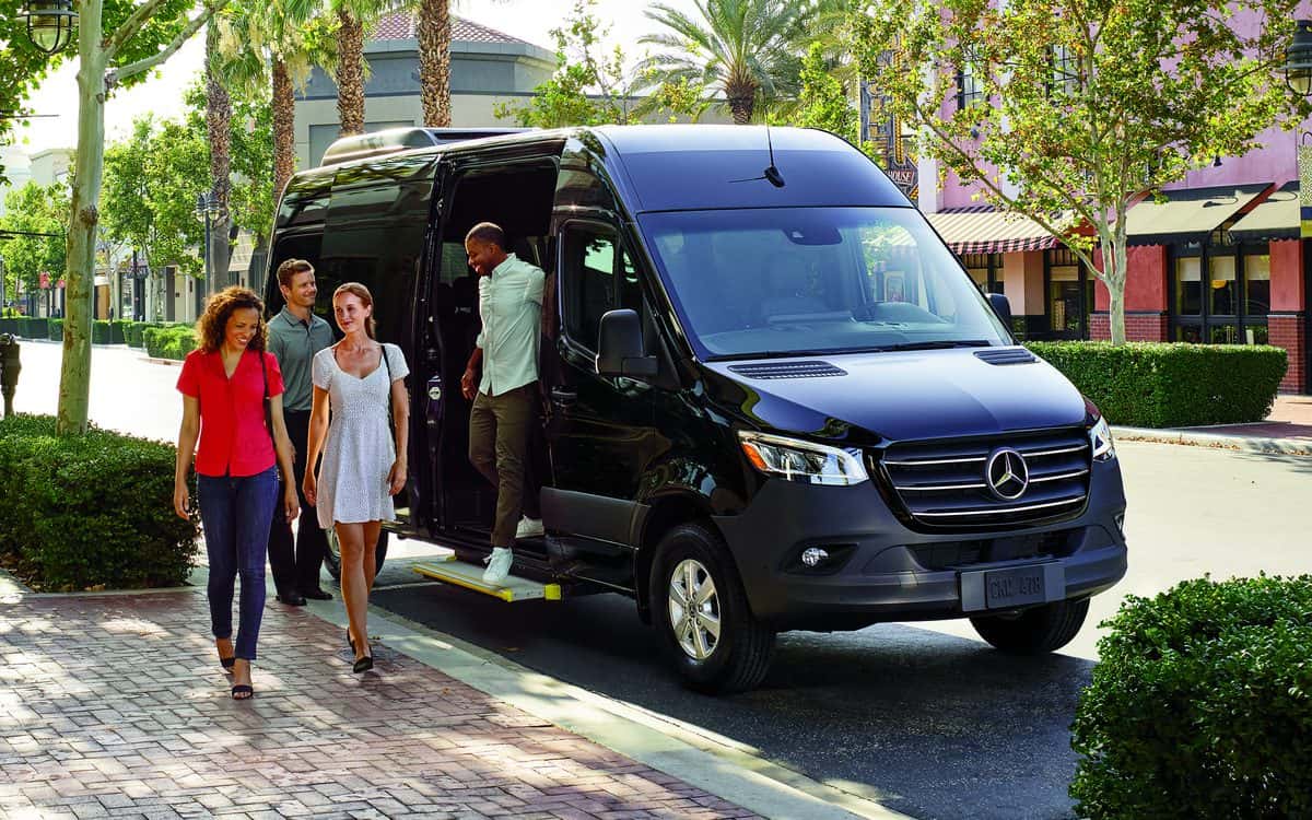 Mercedes-Benz Sprinter Passenger Van at the curb with passengers stepping out