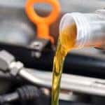 Canister pouring oil into car