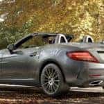 Silver SLC roadster parked in a wooded area
