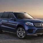 Navy GLS SUV parked on a beach