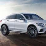 Silver GLC Coupe parked in front of a skyline