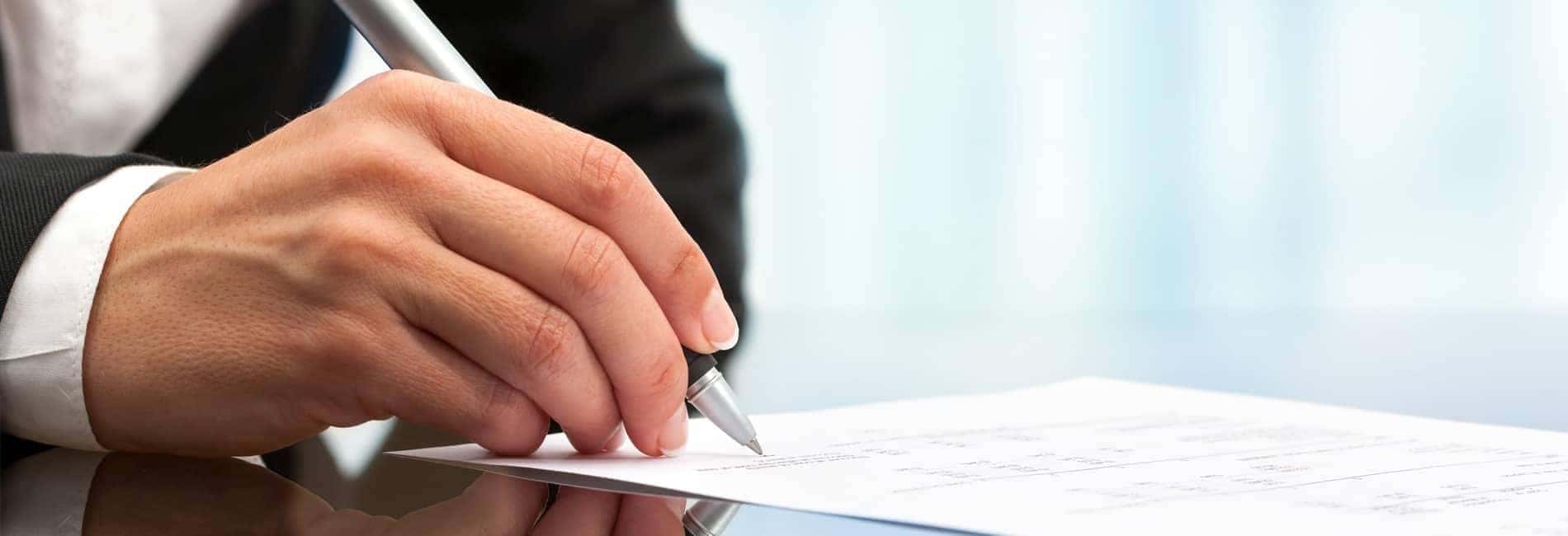 Man signing finance docs
