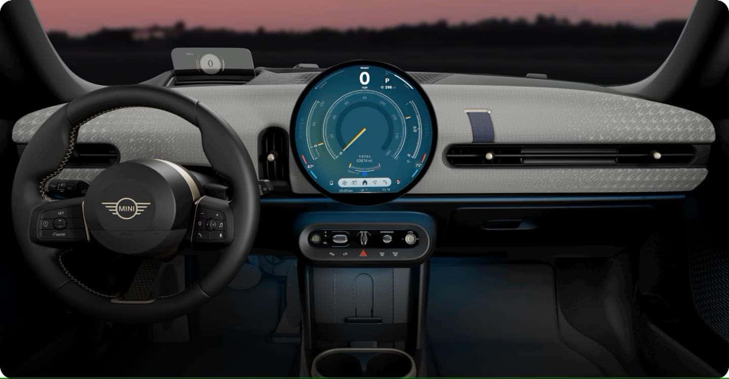 the digital dashboard and round infotainment screen in a mini cooper convertible