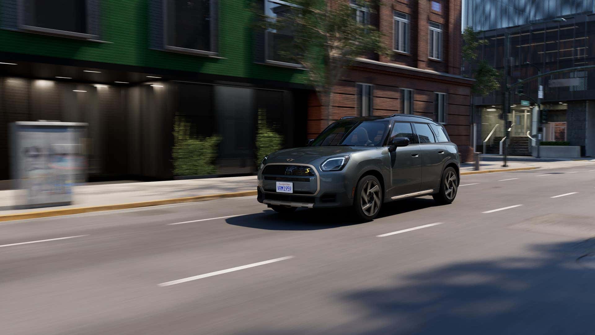 a silver countryman se driving in a downtown city scape