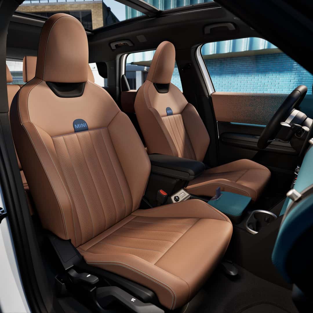 the beige leather interior front seats of a 2025 mini countryman se