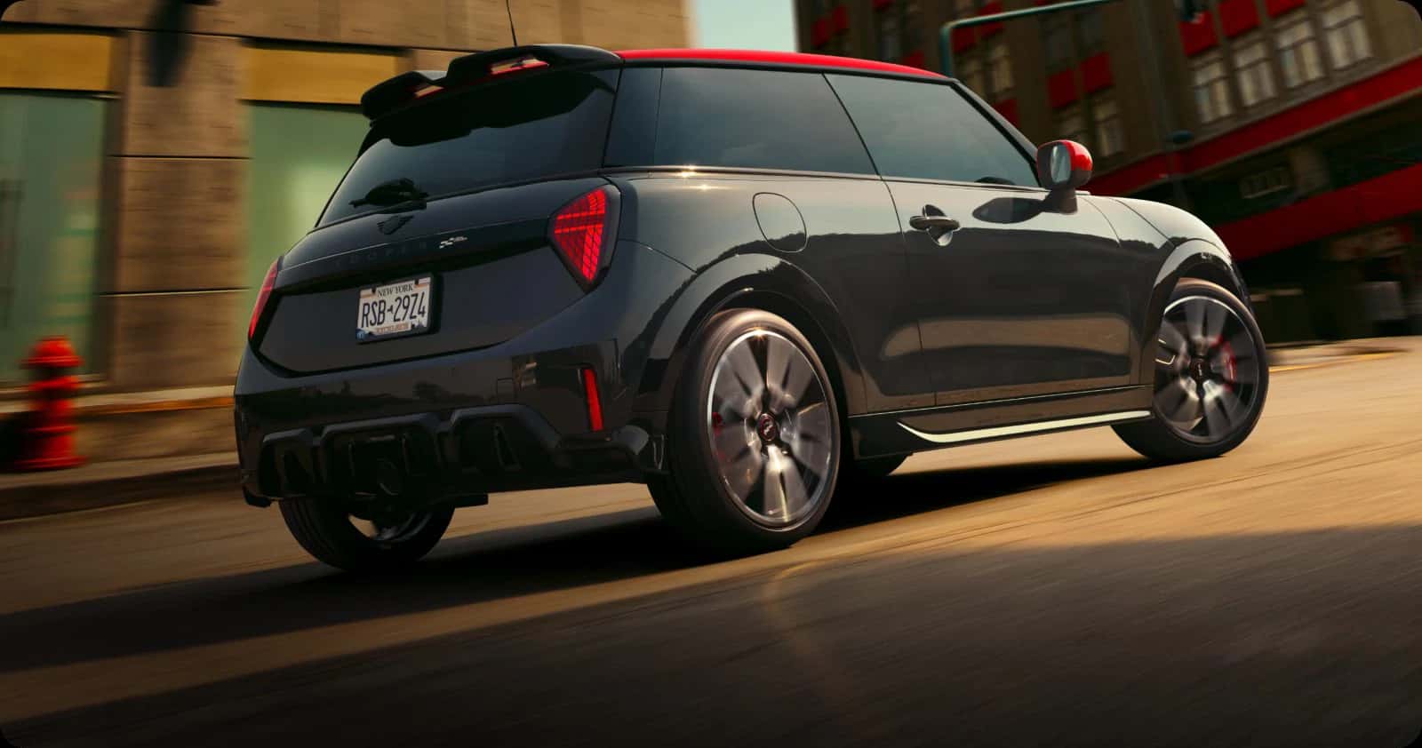 the back exterior of a john cooper works mini cooper 2 door hardtop driving in the city