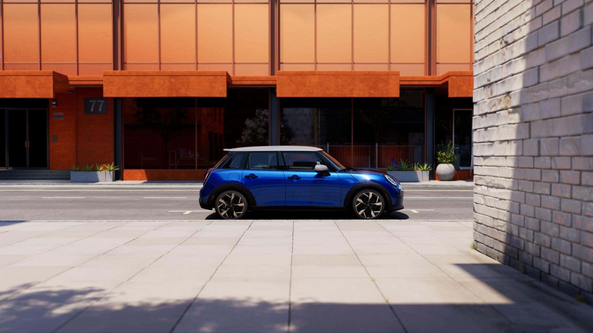 2025 mini cooper 4 door parked next to an orange building