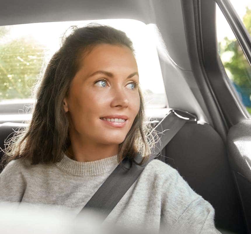 Woman looking out car window